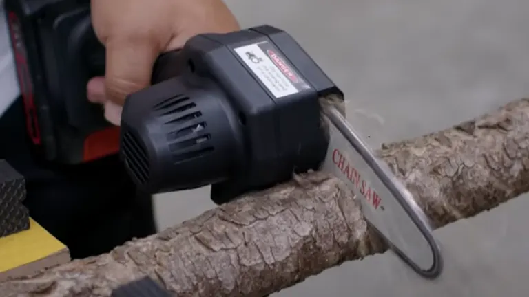 Woodwise Mini Chainsaw cutting through a tree branch during review.