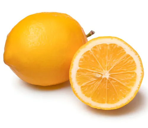 Whole and halved ripe lemon on a white background.