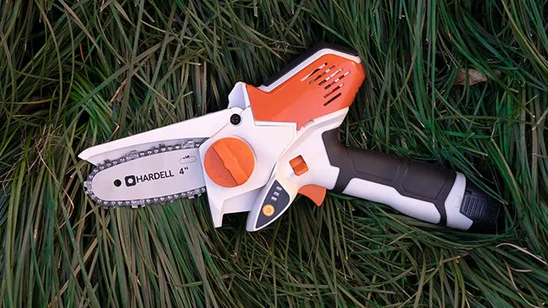 Hardell 4-inch mini chainsaw displayed on grass.