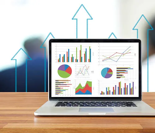 Graphs and charts on a laptop screen analyzing economic conditions and market trends.