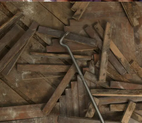 Pile of floorboard slivers used for filling gaps in timber floors, with a crowbar