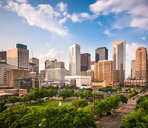 City skyline with green spaces, showcasing the work of urban landscape designers in planning.