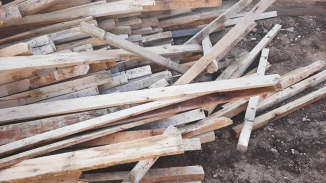 Pile of reclaimed wood salvaged from old structures, ready for repurposing in new projects.