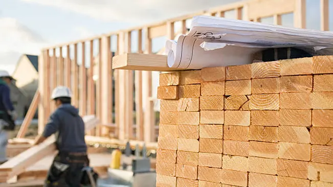 Graded softwood lumber at a construction site, ensuring quality for structural integrity and safety.