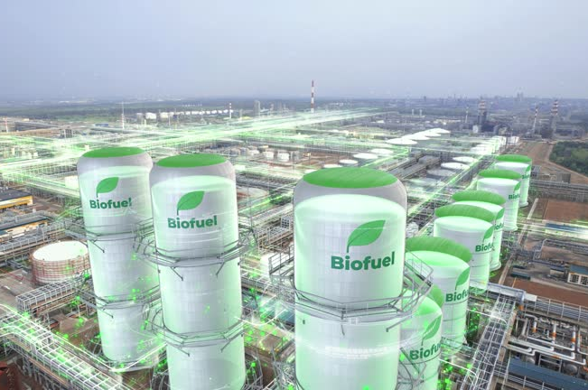 "Modern biofuel facility with large storage tanks labeled with green leaves, connected by pipelines, symbolizing renewable energy production and distribution."