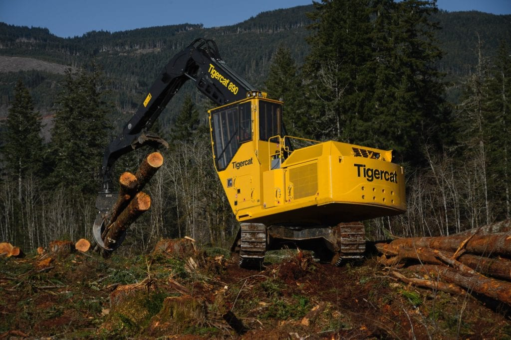 Heavy machinery lifting logs in a forest, emphasizing timber investment potential.