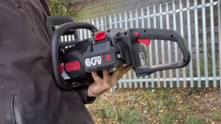 Person holding the Kress Commercial 60V 14-inch top-handle chainsaw, highlighting its compact, ergonomic design.