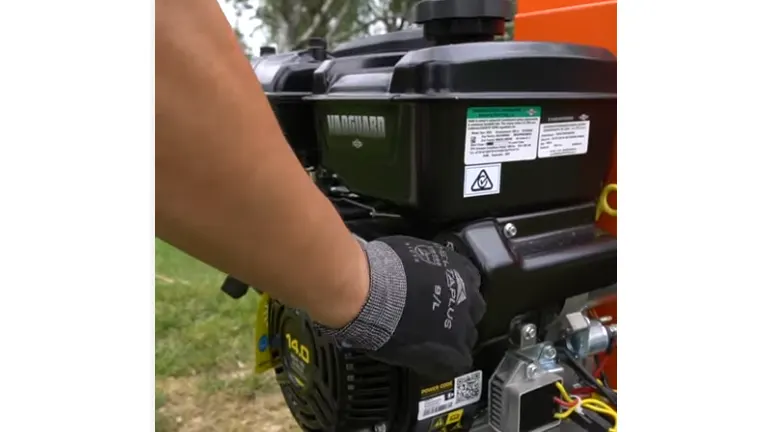 Hand starting the engine of the Ingco WCS350 Gasoline Wood Chipper.