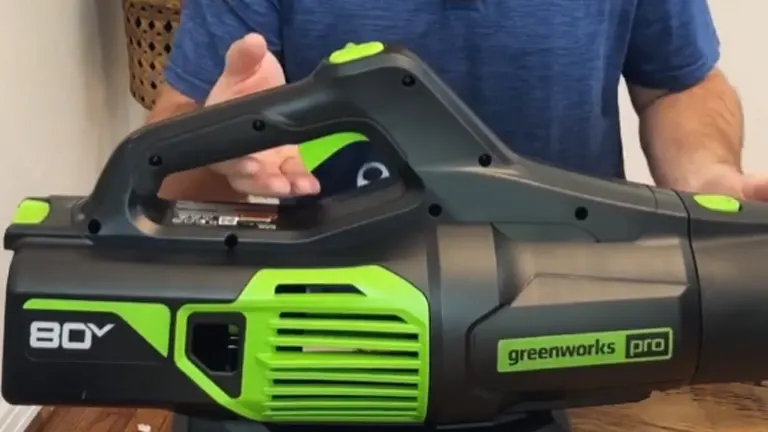 Close-up of the Greenworks Pro 80V leaf blower, highlighting its ergonomic handle and sleek black-and-green design.