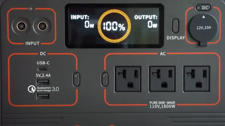 Close-up of Jackery Explorer 1500 solar generator's control panel, showing input/output display, USB ports, AC outlets, and DC carport.