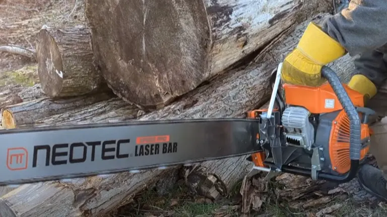 Close-up of NeoTec NS8105 gas chainsaw cutting through large log with laser bar.