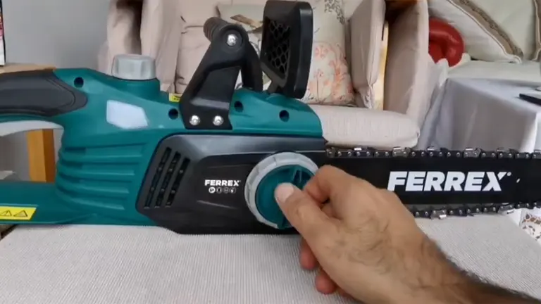 Person adjusting chain tension on a Ferrex Electric Chainsaw Review.