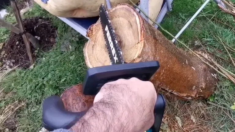 Ferrex electric chainsaw cutting through a large tree log.