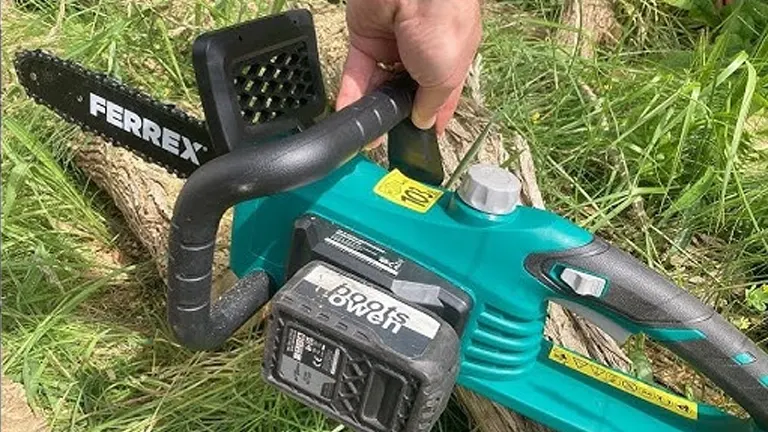 Ferrex electric chainsaw cutting a log outdoors.