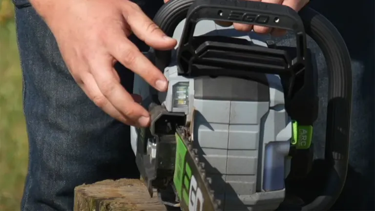 Person checking the oil level on the EGO Power+ CS2005 Cordless Chainsaw.