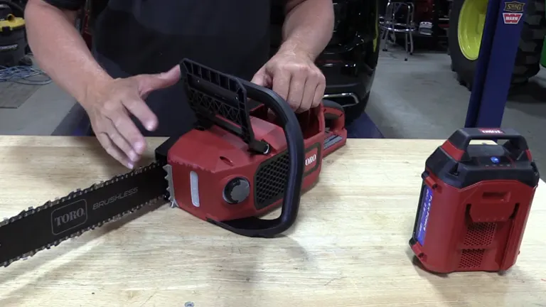 Person demonstrating Toro Flex-Force 60V chainsaw with detached battery on a workbench.